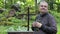 Man with Bible and rosary at outdoors church near cross