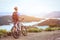 Man with bicycle enjoying panoramic view at sunset