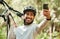 Man, bicycle and forest for selfie, nature or smile for wellness, training or blog on adventure. Influencer guy, cycling