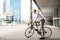 Man with bicycle and headphones on city street