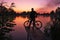 Man with a bicycle on the lookout admires the sunrise or sunset. Sport, active lifestyle. Beautiful colors at dawn