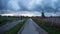 Man on bicycle next to windmill at Zaanse Schans, Netherlands