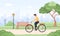 Man on bicycle rides around city. Spring or summer landscape. Happy young boy on bike at park. Sports and leisure