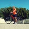 Man on a bicycle in summer day over blue sky, male cyclist in profile