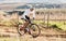 Man, bike and cycling on gravel in nature, countryside and training of triathlon, sports and power. Cyclist, bicycle and