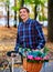 Man on bike with flowers basket in park