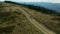 Man with bike mountain view doing active sport hilly road woods background