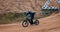 Man, bike and off road for race, adventure or action on sand at cycling rally in Dubai. Electric bicycle, professional