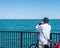 Man on bike taking photo of Lake Michigan