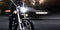 A man biker on a motorcycle in the evening on a city street. Close-up. Night motorcyclist