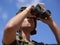 Man with binocular, soldier surveillance and search enemy location on battlefield during Israel Palestine war. Army