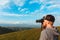 Man Binoculars Looking Mountain Caucasian Elbrus view Cloudscape Traveling Concept