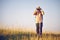 Man with binoculars on meadow