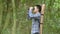 Man with binoculars telescope in forest looking destination as lost people or foreseeable future. People lifestyles and leisure