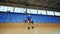 A man with a bionic leg is sitting with a basket ball in a spacious gym