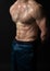 Man on black background keeps dumbbells pumped up in fitness bodybuilding biceps black, body muscular fitness athletic