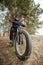 A man on a black fatbike with an electric motor. A favorite sports hobby of many people