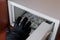 A man in a black glove steals banknotes from a metal safe with a combination lock. Breaking into a safety Deposit box. Criminal