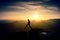 Man in black jumping between peaks. Dreamy daybreak