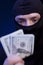 Man in black mask holding the money