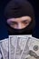 Man in black mask holding the money