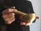 A man with a black shirt playing a tibetan bowl