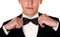 Man in a black suit adjusts his bow tie close-up face