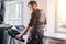 Man in black suit for ems training running on treadmill at gym