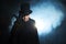 Man in a black top hat and cloak. Demonic image. Magician illusionist