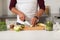 Man with blender and fruit cooking at home kitchen