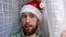 Man blogger santa hat look out the curtain merry christmas and happy new year