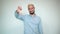 Man with blond hair, black beard over isolated white background shows emotions