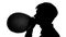 Man is blowing a balloon. Silhouette. Close up. White