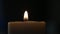 Man Blowing and Extinguishing a Lighted Candle in a Dark Room in Time of an Accidental Power Failure.