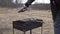 Man blowing fire on the grill by plastic plank. with grille full of meat.