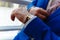 Man in a blue expensive suit and vest looks at expensive watches. closeup designer watch on businessman hand, he looks on the time