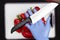 A man in blue hygiene gloves cuts red sweet peppers at home