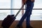 Man on blue jeans with carry on suitcase at Las Palmas airport terminal