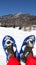 Man with blue modern snowshoes in the mountain