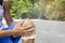 Man with blue runing shorts use hands hold on his knee after running on road in morning time with copy space for text or design