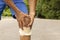 Man with blue runing shorts use hands hold on his knee after running on road in morning time with copy space for text or design