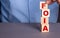 A man in a blue shirt composes the word FOIA The Freedom of Information Act from wooden cubes vertically