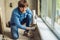 Man in a blue shirt does window installation. Using a mounting foam