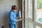 Man in a blue shirt does window installation. Using a mounting foam