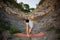 Man in blue shirt doing second step of surya namaskar, uttanasana forward bending pose