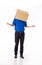 Man in a blue T-shirt with a cardboard box on his head makes a gesture with his hands