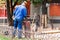 A man in a blue uniform and helmet unscrews the valve of the propane tank. Construction work