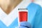 Man in blue uniform holds shaving machine closeup