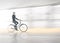 Man in blurred motion cycling along wet road