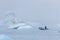 Man on a boat between bizarre ice floes of Iceberg lagoon jokulsarlon on the south of Iceland